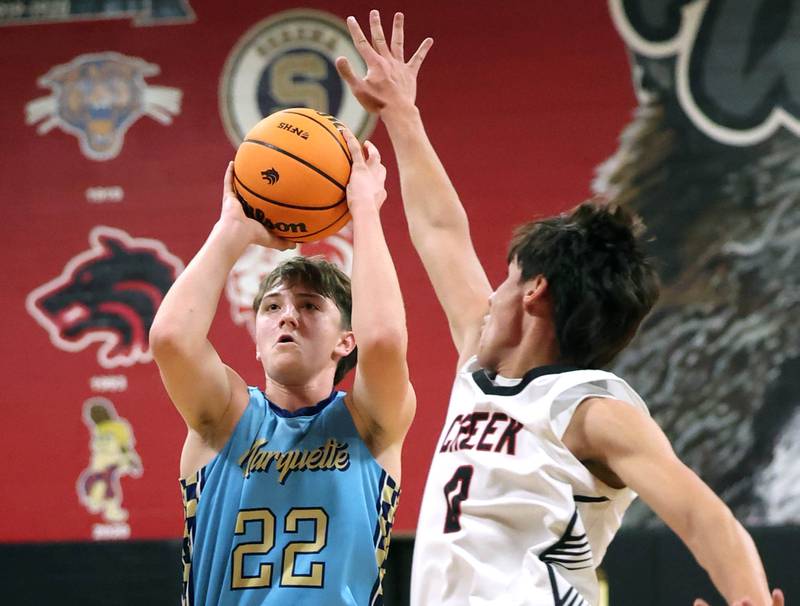 Marquette’s Griffin Dobberstein shoots over Indian Creek's Cooper Rissman Monday, Dec. 9, 2025, during their game at Indian Creek High School in Shabbona.