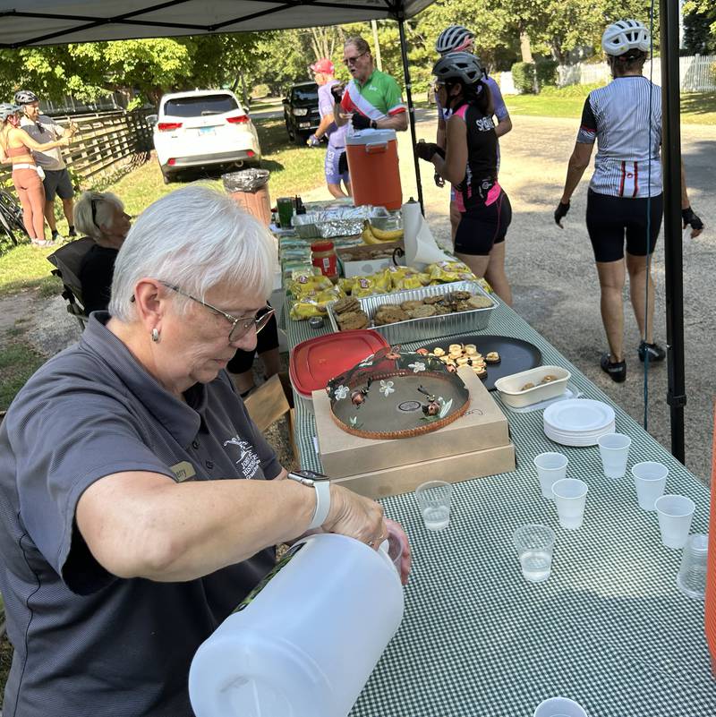 Sherry Monroe pours pickle juice for  bicyclists at the John Deere Historic Site rest stop during the 10th annual TOSOC (Tour of Scenic Ogle County) on Saturday, Sept. 27, 2025.