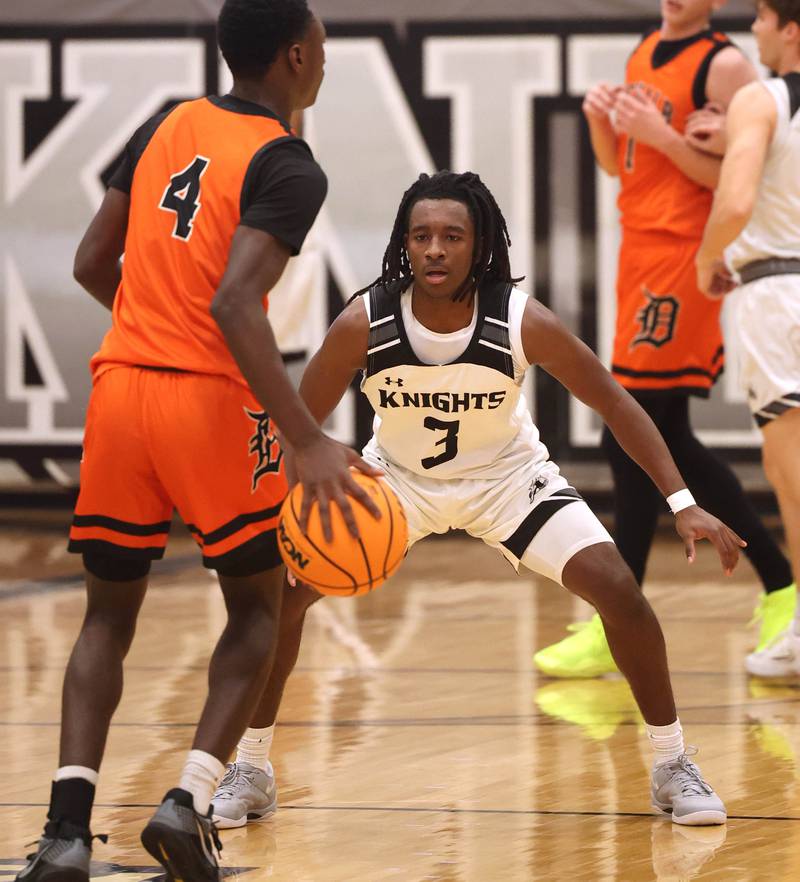Kaneland's Marshawn  Cocroft plays defense against DeKalb's Marquise Bolden during their game Tuesday, Jan. 28, 2025, at Kaneland High School in Maple Park.
