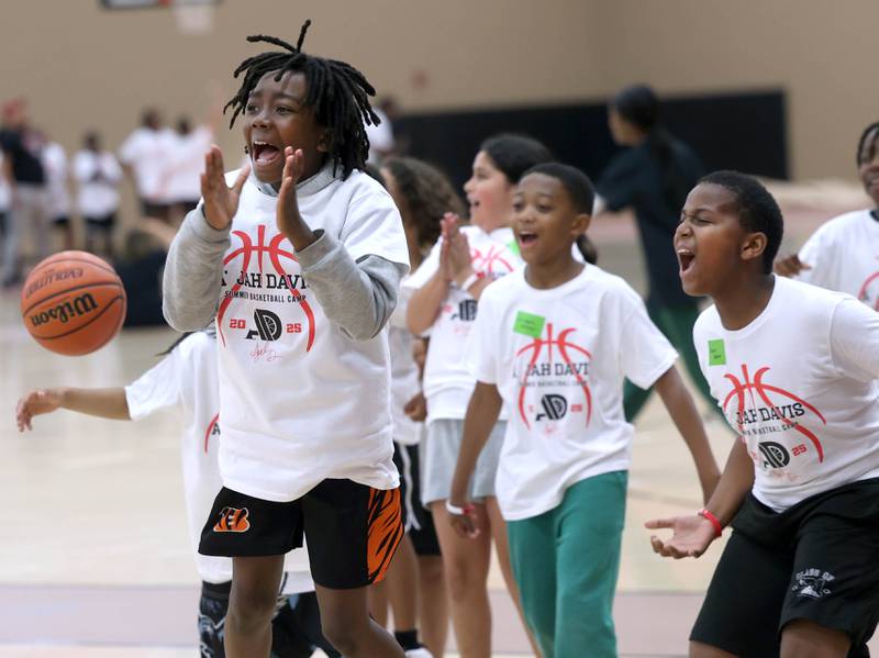 Participants celebrate winning a relay race Saturday, May 24, 2025, during the A'Jah Davis Foundation Basketball Camp and Wellness Day at DeKalb High School.