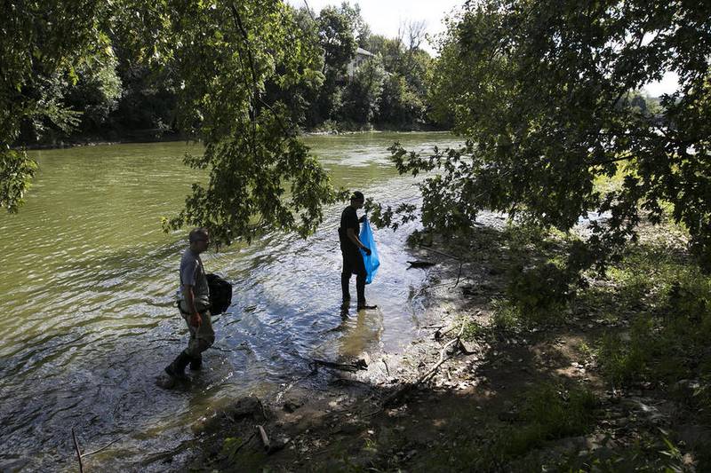 Pat Okonek (left) of Palatine and his son, Tim Okonek, 15, help pick up trash around the Fox River in Algonquin during the ninth annual "It's Our River Day" celebration Sept. 17. 2016. The environmental Defenders of McHenry County and the village of Algonquin sponsored the local celebration and clean up.