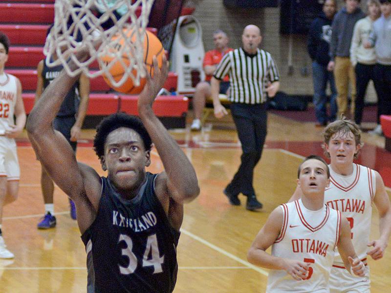 After grabbing a loose ball, Kaneland’s Jeffrey Hassan leaves the Ottawa defense behind for a dunk in the 2nd quarter Tuesday at Ottawa.