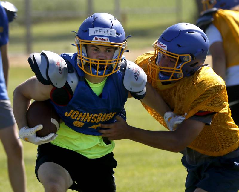 Jake Metze runs with the ball during summer football practice Thursday, June 23, 2022, at Johnsburg High School in Johnsburg.