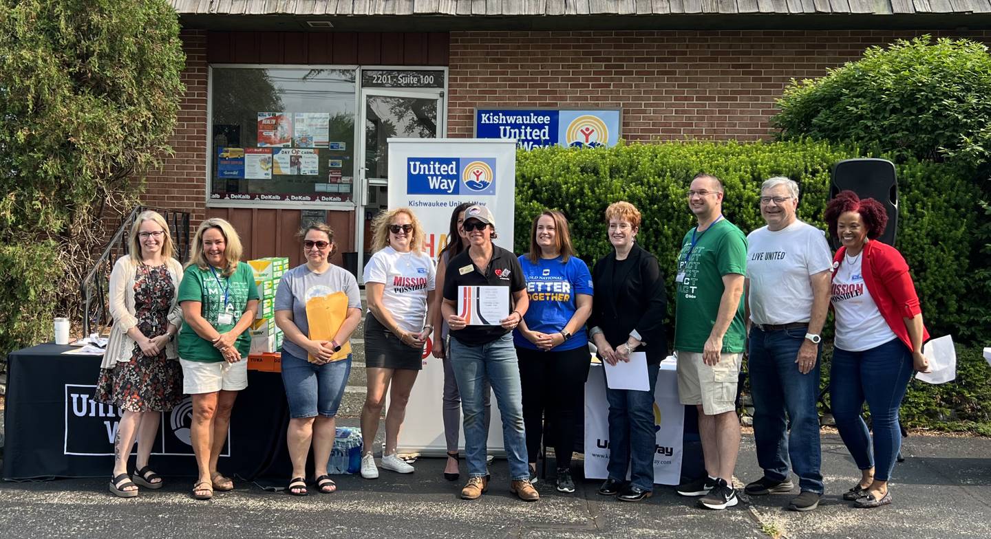 Cami Loving, with Voluntary Action Center, stands with the Kishwaukee United Way's Board of Directors after the action center was awarded $25,000 on June 15, 2023.