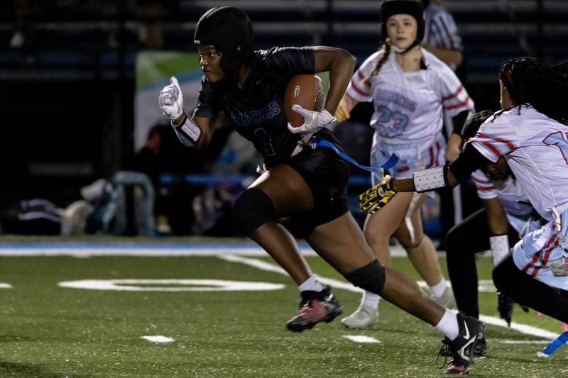 Willowbrooks's Jada Langston picks up yardage during a varsity flag football IHSA State Quarterfinals game against Kenwood, held at Willowbrook High School on Oct. 17, 2025.