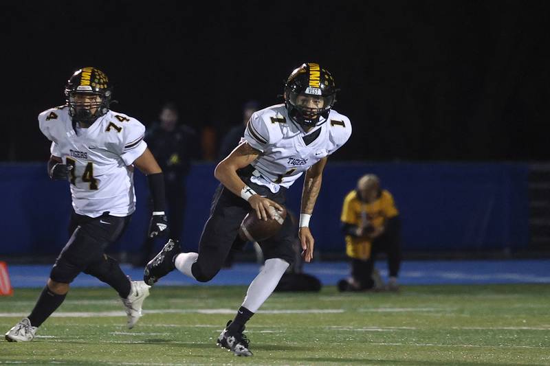 Joliet West’s Antoine Brooks rolls out of the pocket against Lyons Township in the first round of the playoffs on Friday, Nov. 1, 2024 in La Grange.