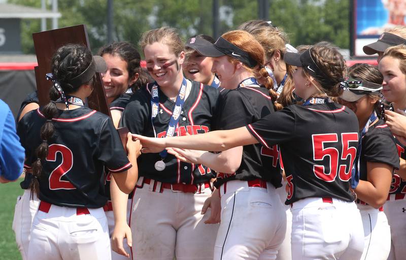 Members of the Benet Academy softball team hold the Class 3A State third place trophy on Saturday, June 10, 2023 at the Louisville Slugger Sports Complex in Peoria.