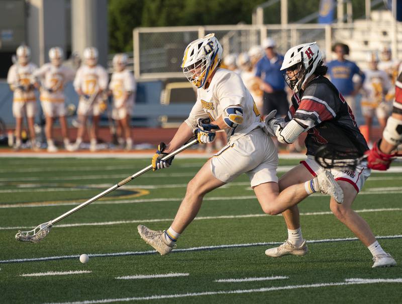 Lake Forest's John Carrabine gets pressure from Huntley defender Cole Copersmet during the boys lacrosse supersectional match on Tuesday, May 31, 2022 at Hoffman Estates High School.