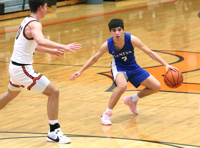 Geneva’s Gabe Jensen works against DeKalb’s Eric Rosenow Thursday Dec. 28, 2023, during their second round game in the 96th Chuck Dayton Classic boys basketball tournament at DeKalb High School.