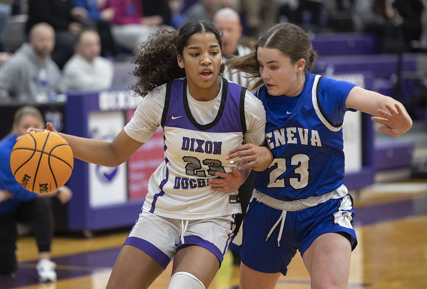 Dixon’s Ahmyrie McGowan works against Geneva’s Nora Hatton in the Class 3A girls basketball regional title game.