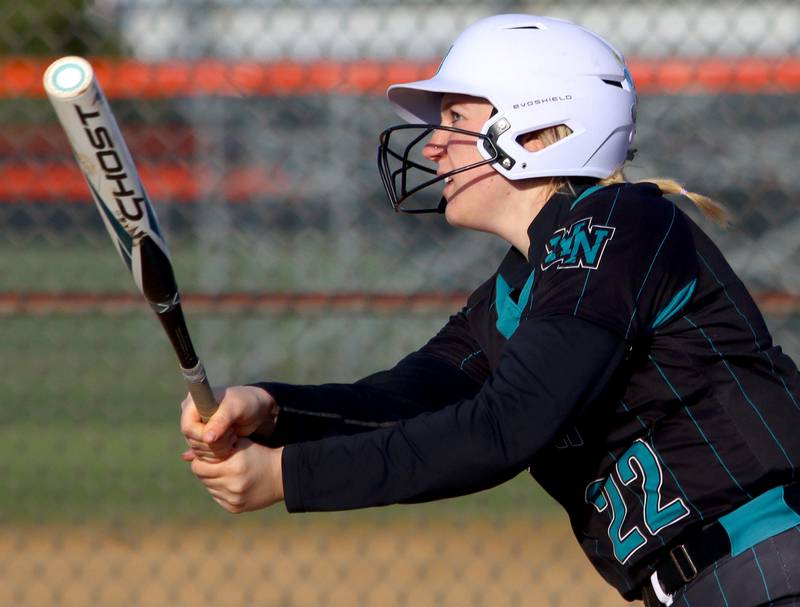 Woodstock North’s Jo Jo Vermett watches her homer leave the yard in varsity softball at Crystal Lake Central Friday.