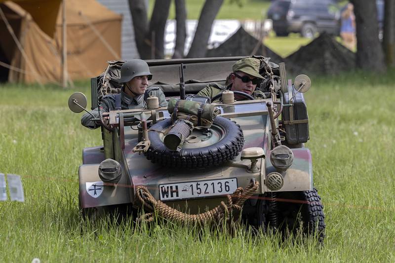 Reenactors speed around in a vehicle Saturday, May 16, 2026, portraying the Battle of Anzio in Franklin Grove.