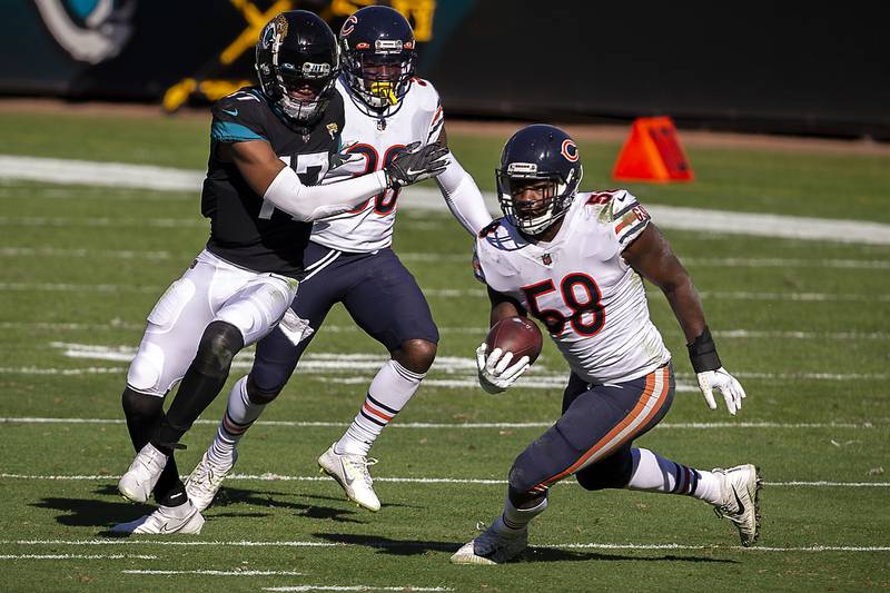 Chicago Bears linebacker Roquan Smith (58) runs the ball after intercepting a pass intended for Jacksonville Jaguars wide receiver DJ Chark Jr. (17) during the first half of an NFL football game, Sunday, Dec. 27, 2020, in Jacksonville, Fla. (AP Photo/Stephen B. Morton)