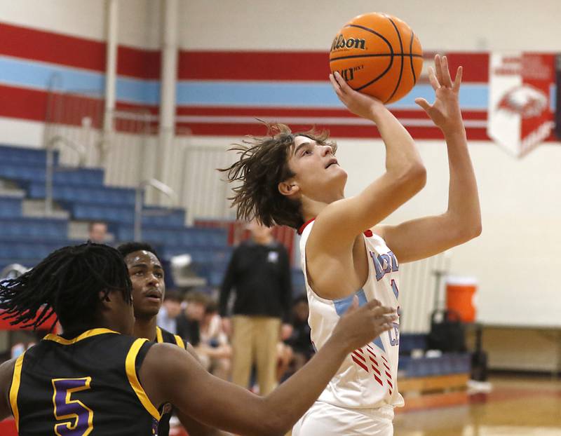 Marian Central's Stefan Stojich shoots the ball in front of Chicago Christian's Malachi Kreider during a Chicagoland Christian Conference basketball game on Tuesday, Jan. 21, 2025, at Marian Central High School.