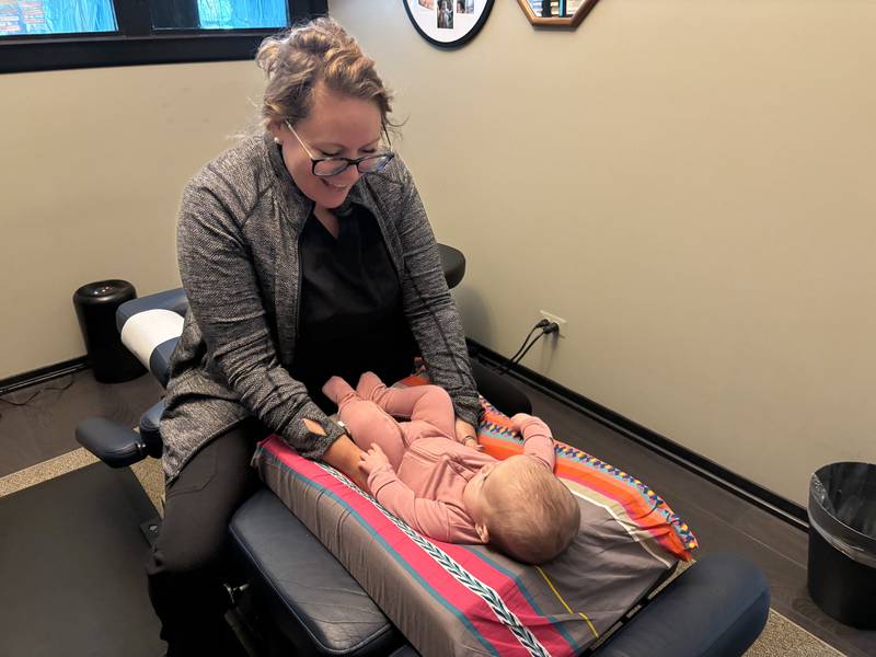 Dr. Jade Dellinger, a pediatric chiropractor and functional medicine practitioner, performs an adjustment on one of her young patients, 3-month-old Elsie, at North Shore Pro-Active Health in Libertyville.