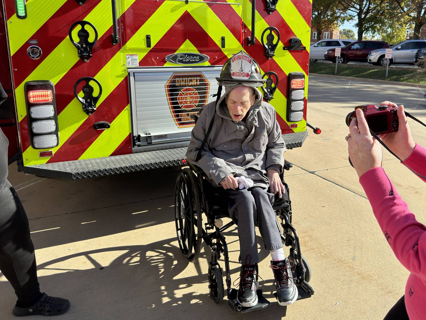 Alan tries on a fireman's helmet to get his picture taken with the Dwight firetruck.