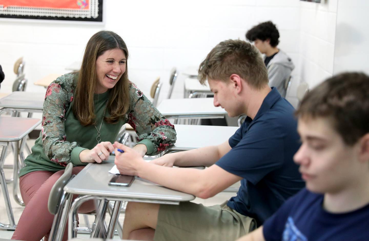 Wheaton Warrenville South teacher Katie Valentino checks in with sophomore Ethan Szafranski during a class at the high school. Valentino was recently honored with a Community Unit School District 200 Distinguished Educator Award.