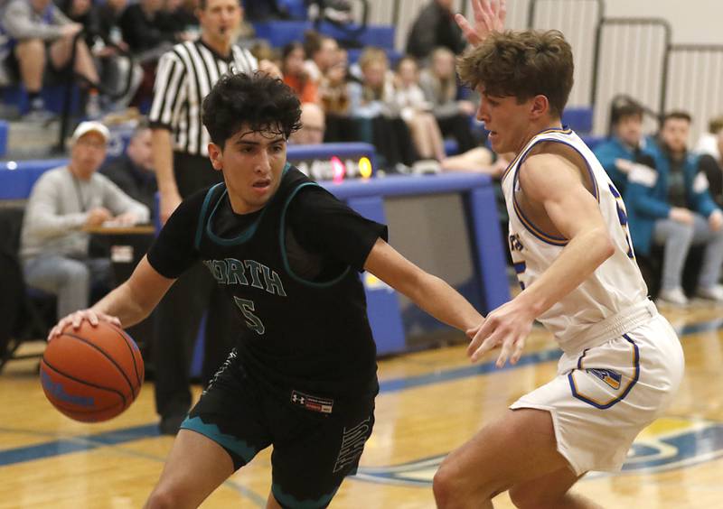Woodstock North's Cesar Ortiz drives the baseline agains tJohnsburg's Kyle Patterson during a Kishwaukee River Conference boys basketball game Wednesday, Jan. 18, 2023, at Johnsburg High School.