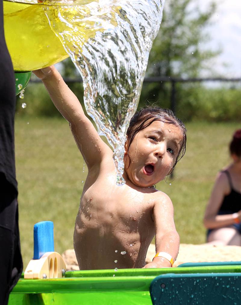 Adrian Martinez, 2, from DeKalb, gets ready to be hit with some water Tuesday, June 24, 2025, on the Splash Fountain Splashpad at the Sycamore Park District Community Center.