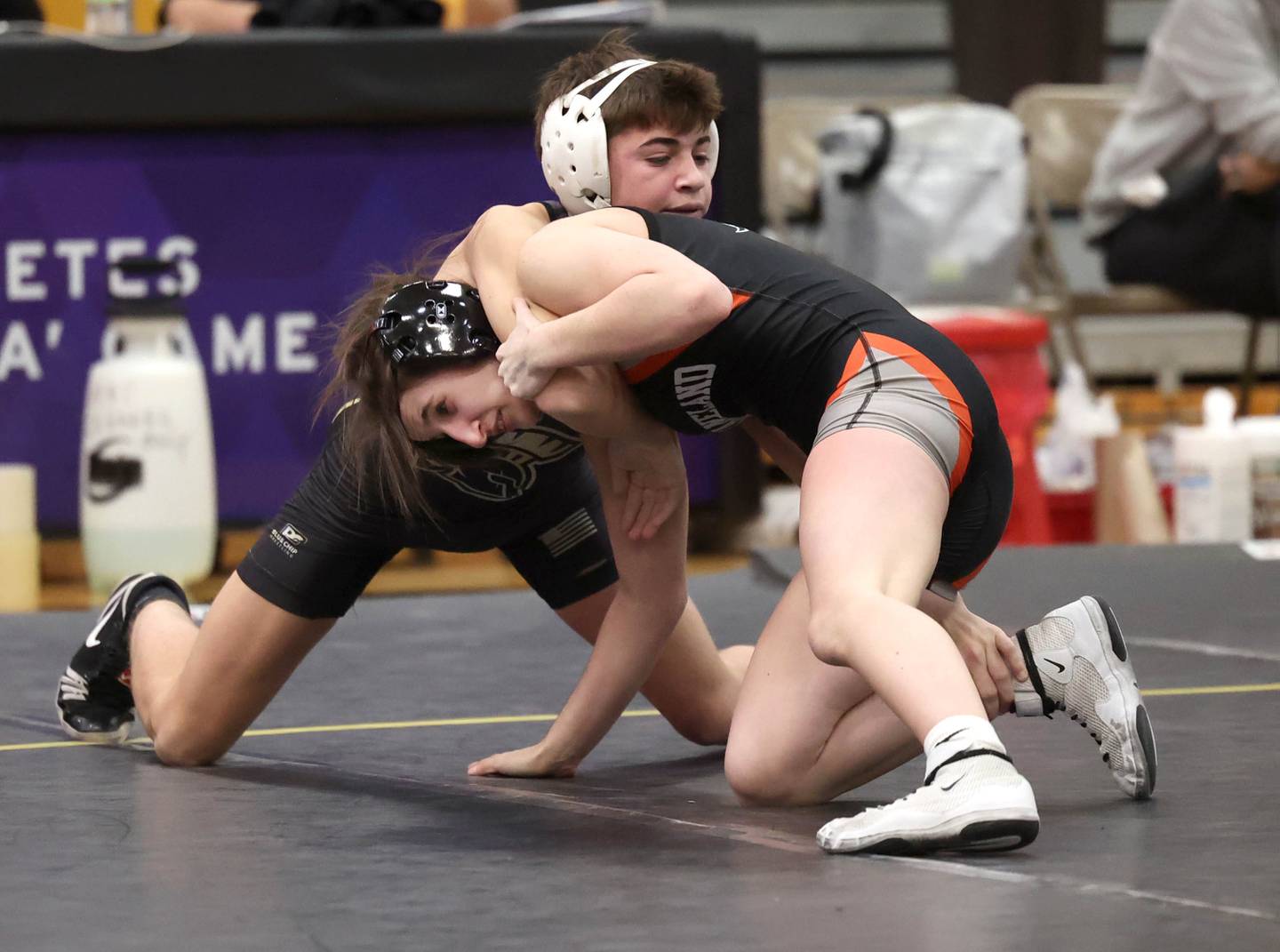 Sycamore’s Charlie Olson wrestles Kaneland’s Angelina Gochis during their 113 pound match Thursday, Jan. 9, 2025, at Sycamore High School.