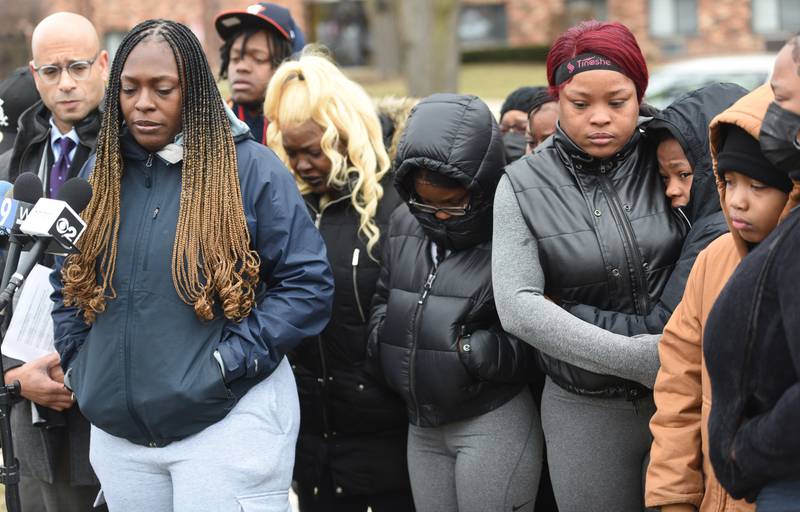 Civil rights attorney Andrew M. Stroth, left, conducts a press conference on Monday, Feb. 4, 2024 for the family of Isaac Goodlow III who was shot and killed by Carol Stream police officers over the weekend. Isaac's sister, Kyenna McConico, second from left, says a few words as family members console each other.