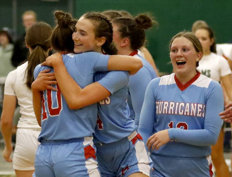 Marian Central's Juliette Huff (center) is hugged by her teammate, Marian Central's Adriana Wrzos after Huff scored her1,000 career point during a nonconference girls basketball against Grayslake Central on Monday, Jan. 13, 2025, at Grayslake Central High School.