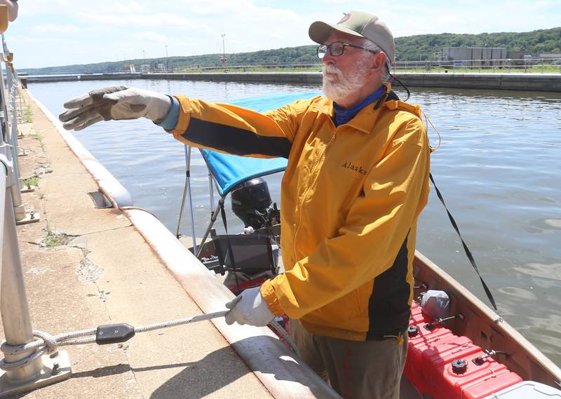71 year old adventurer and thyroid cancer survivor Robert Youens, talks to people while locking at the Starved Rock Lock and Dam on Monday, July 28, 2025 near Utica. Youens is making  the Great Loop, a 6,000 mile journey on his Jon boat something that hasn't been done before. Youens is looking at setting a record for the longest someone has gone on a Jon boat.