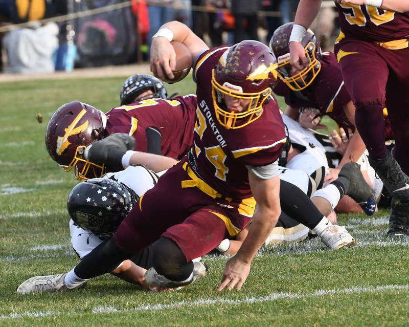 Stockton's Jack Mensendike (24) fights for yards against Lena-Winslow in 1A semifinal action in Stockton on Saturday, Nov. 22, 2025.