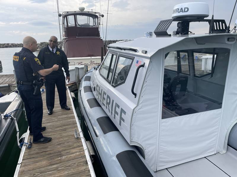 Sheriff John D. Idleburg receives a briefing from Marine Unit Sgt. Ari Briskman.