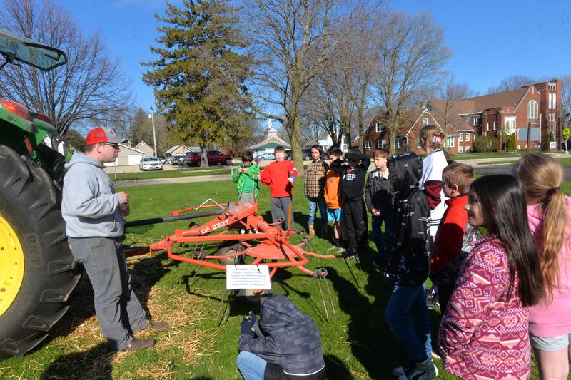 Forreston High School FFA member Justin Myers of Adeline talks to Forreston Grade School third grade students about farm machinery during the Forreston FFA's Ag Day on Friday, April 12, 2024. In addition to the petting zoo, the event included a petting zoo featuring farm animals.