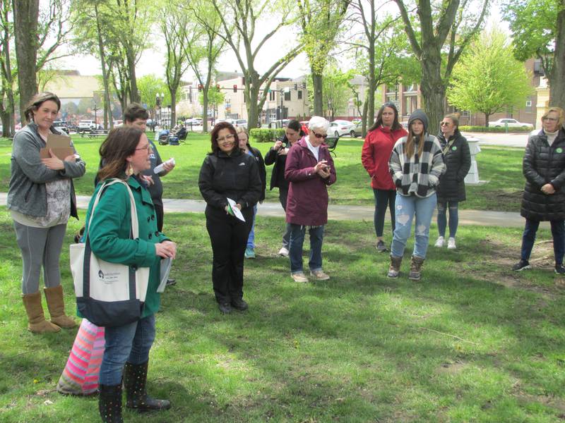 Melissa Engel, of Safe Journeys, talks to people at the March to Believe event Saturday, April 29, 2023, at Washington Square in Ottawa about helping victims of domestic and sexual abuse.