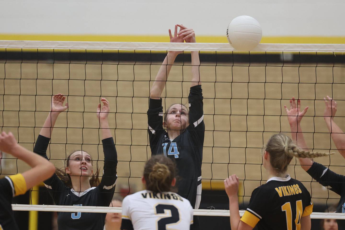 Joliet Catholic’s Emma Vitas blocks a shot for a point against St. Laurence in the Class 3A Hinsdale South Super-sectional on Friday
