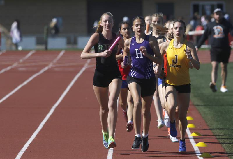 Runners compete in the 4 x 800 meter relay on Thursday, May 8, 2025, during the Fox Valley Conference Girls Track and Field Meet at Huntley High School.
