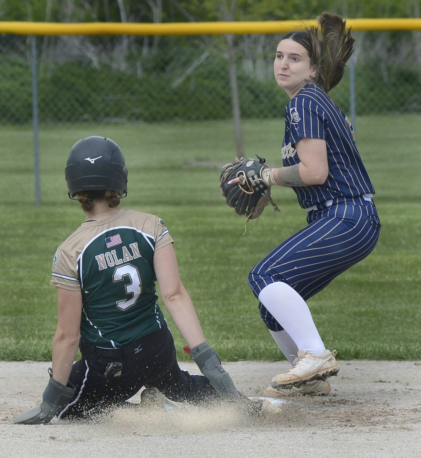 Marquette’s Makayla Backos tries to get the force out on Elgin St Edward’s Alania Nolan at 2nd base Wednesday at Serena.