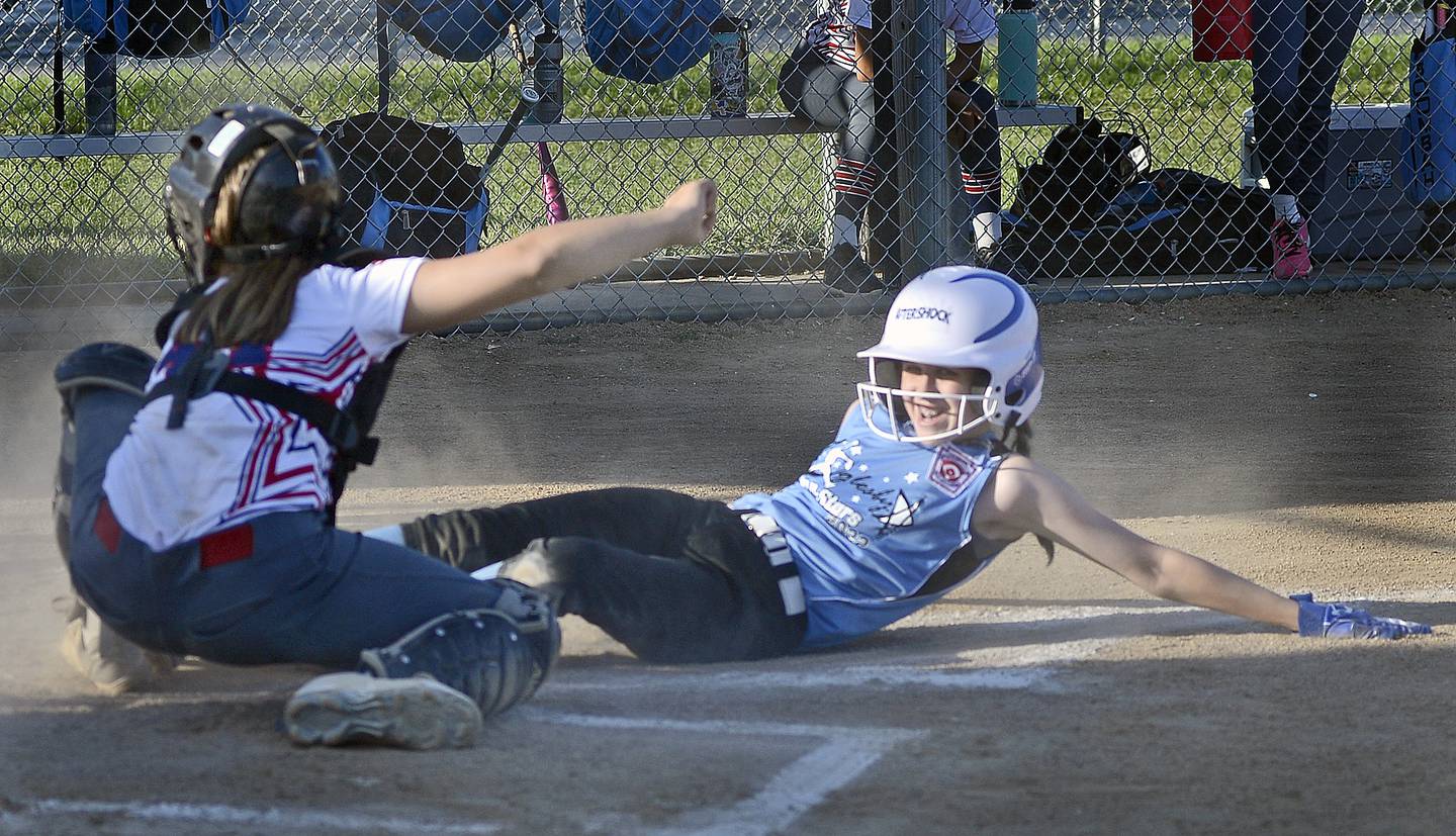 Oglesby runner Bethany Kasperski is tagged out a home by La Salle catcher Ali Inman in Thursday's District 20 Minor League title game at La Salle.
