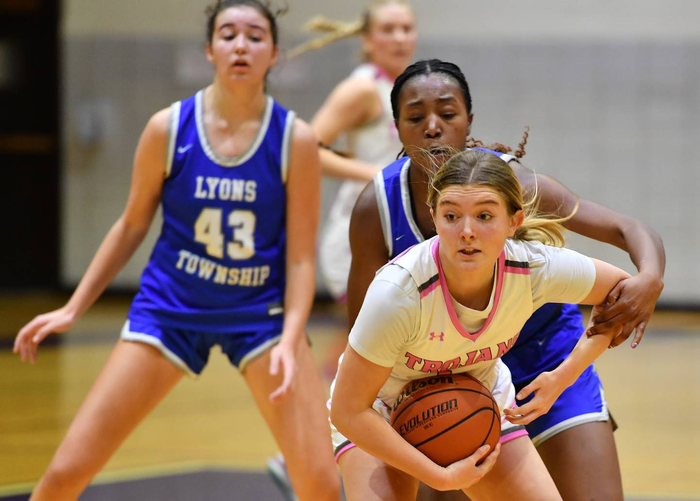 Downers Grove North's Abby Gross is fouled from behind by Lyons Township's Nora Ezike near the end of a game on Jan. 30, 2024 at Downers Grove North High School in Downers Grove .