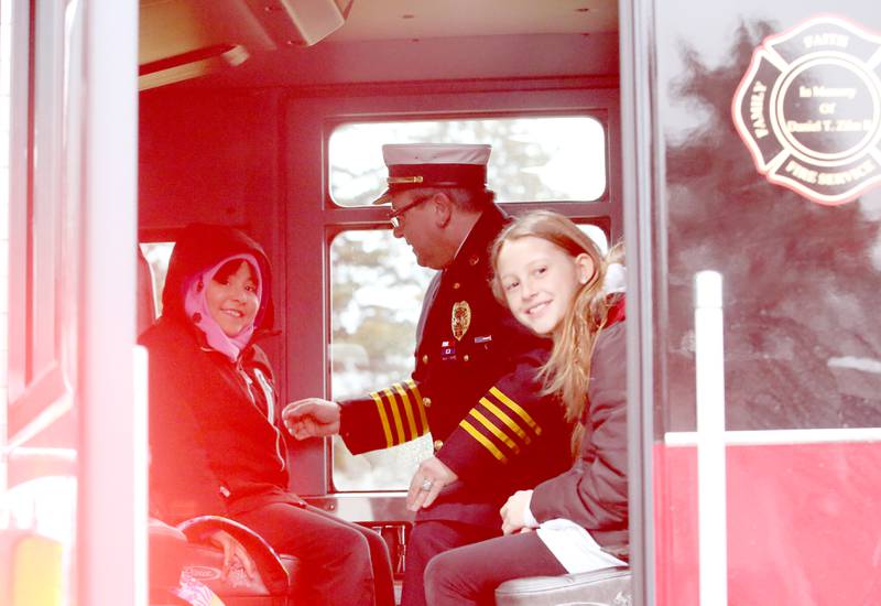 Putnam County Elementary students Priscilla Serna and Arya King smile as they are seatbelted in a fire engine by deputy chief Quentin Buffington after winning the Hennepin Fire Department Escape Floor plan contest on Tuesday, Nov. 1, 2023. Students had to draw a floor plan or map of their home showing all doors and windows. Smoke alarms had to be marked in each plan. A family meeting place was also required to be marked on the drawings. The Hennepin Fire Department has been holding the contest for several years. The department stopped the event during Covid and continued it for the first time since the pandemic this year. The department picks the winning children up on a firetruck and busses them to school.