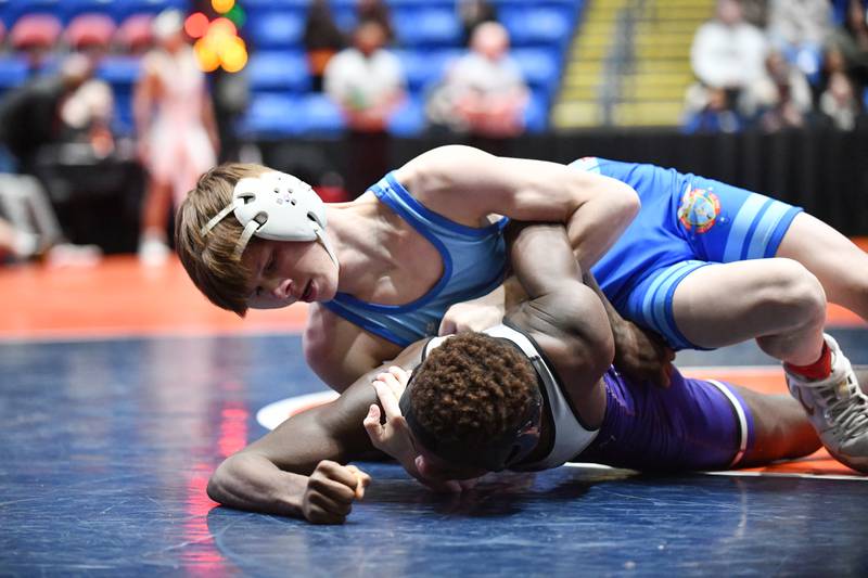 Colton Wyller of Marmion Academy, top, wrestles Kristian DeClercq of Hononegah, during Wyller's 113-pound victory during the IHSA Dual Team State Finals in Bloomington on Saturday, March 1.