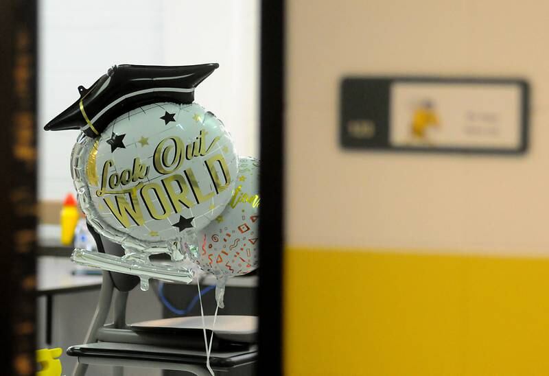 A graduation balloon peeks out of a class room Sunday, May 22, 2022, during the Harvard High School Commencement Ceremony in Harvard .
