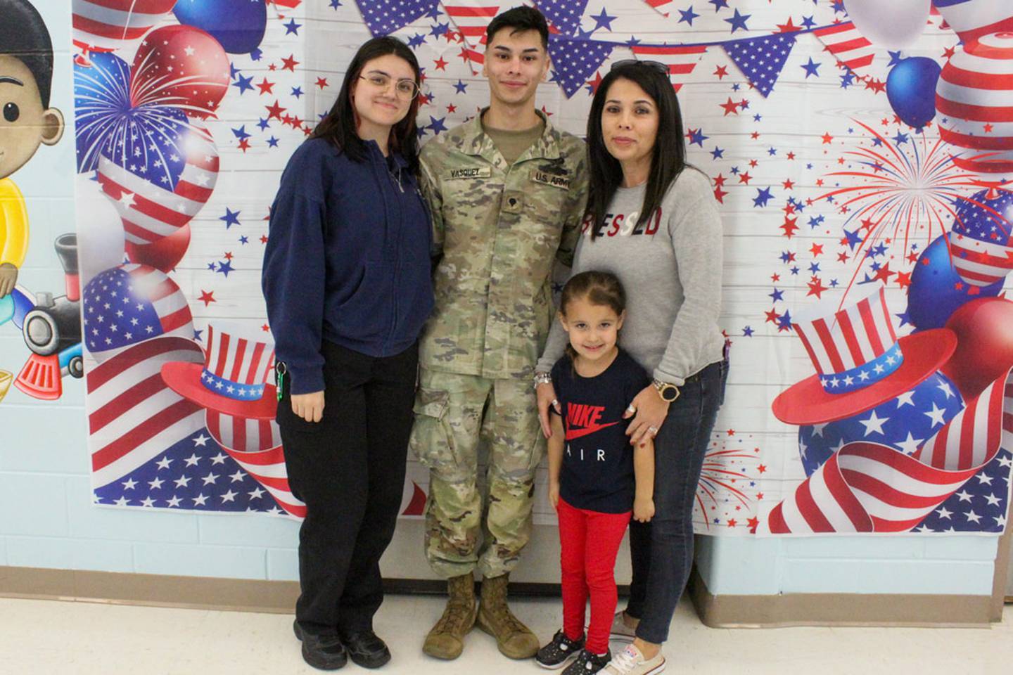 Tina Vasquez, paraprofessional at Bonnie McBeth Early Learning Center in Plainfield (far right), stands with her family after the Veterans Day parade at Bonnie McBeth in 2024. Vasquez organized a parade in which local veterans walked through the school’s halls and interacted with the students.