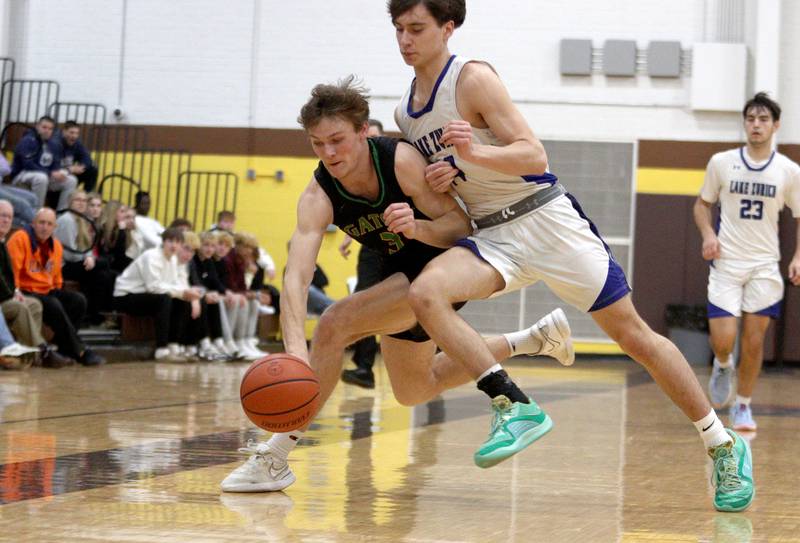 Crystal Lake South’s Colton Hess, left, races Lake Zurich’s Adrian Riep for the ball in Hinkle Holiday Classic boys basketball tournament game action at Jacobs High School Wednesday.