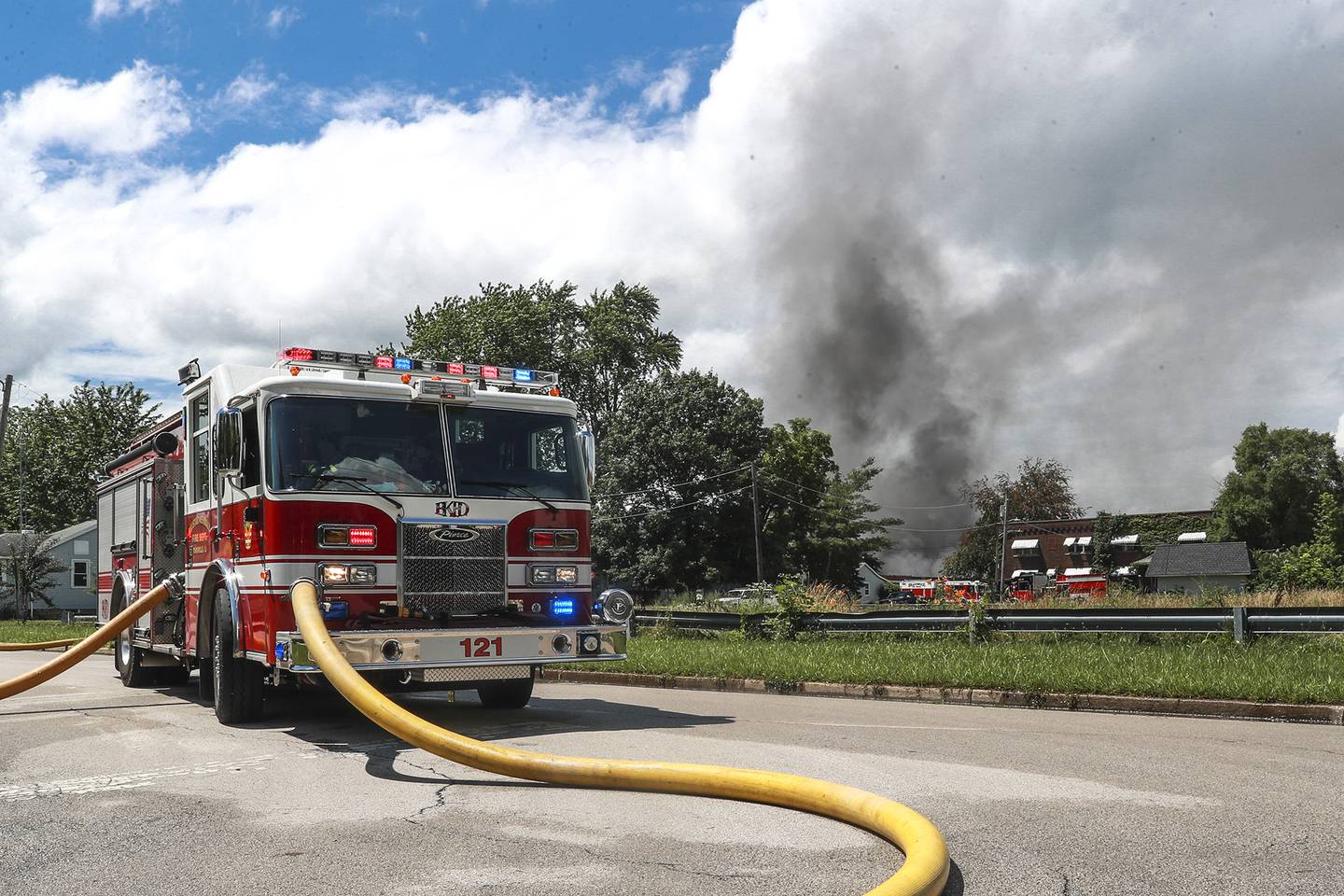 A firetruck pumps water from a nearby hydrant to fight the blaze on Tuesday, June 29, 2021, at the 900 block of East Benton Street in Morris, Ill. Over 40 homes in the area have been evacuated after an industrial building caught fire late Tuesday morning.