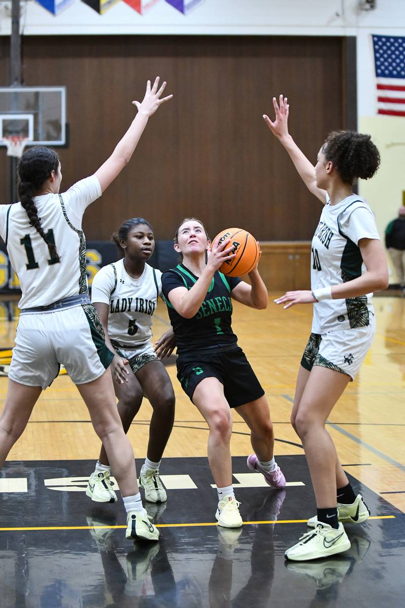 Seneca's Alyssa Zellers looks to shoot under pressure from Bishop McNamara defenders during the Lady Irish's 51-30 loss to Bishop McNamara in the IHSA Class 2A Herscher sectional semifinal on Tuesday, Feb. 25.