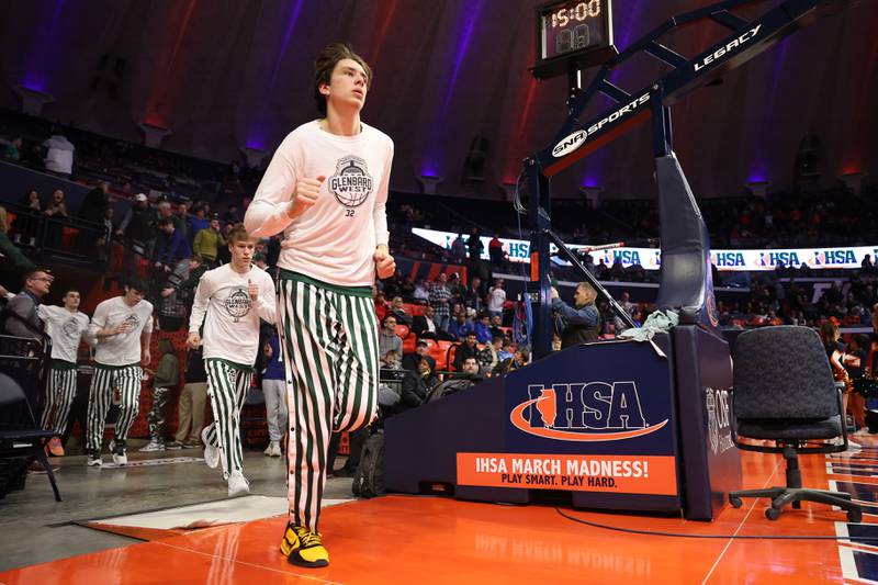 Glenbard West’s Braden Huff enters the arena with the team before the game against Whitney Young in the Class 4A championship game at State Farm Center in Champaign. Saturday, Mar. 12, 2022, in Champaign.
