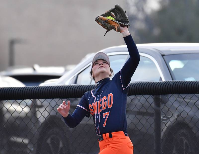 Oswego’s Bella Lisle makes a running catch at the center field fence during a game against Wheaton Warrenville South on April 10, 2025 at Wheaton Warrenville South High School in Wheaton.