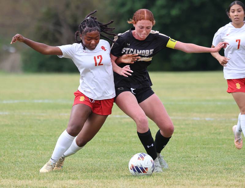 Sycamore's Isabelle Segreti (right) and Rock Island's Chukiwa Sudi collide at the ball Friday, May 22, 2026, during their Class 2A regional championship matchup at Sycamore High School.