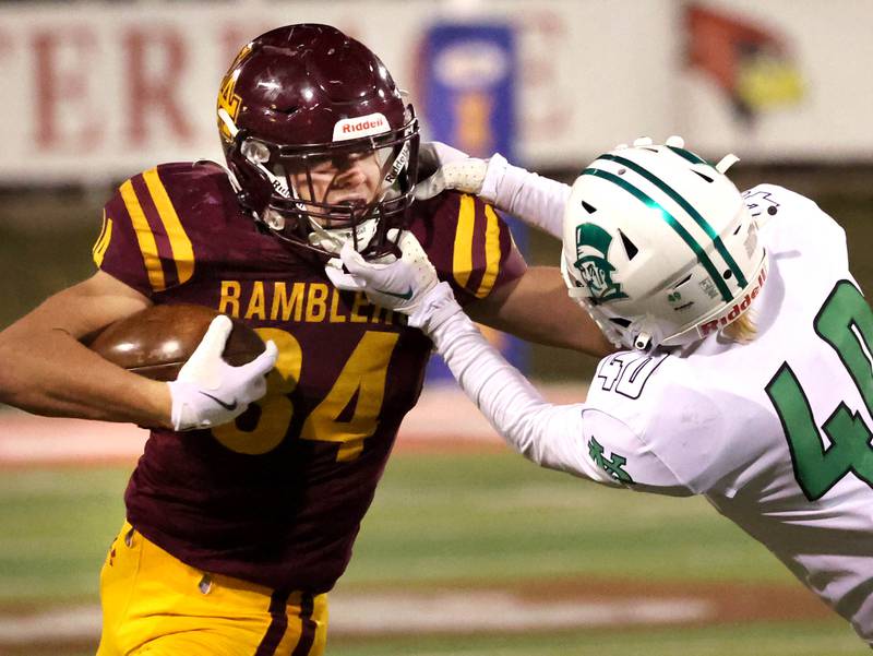 Loyola Academy's Drew MacPherson tries to pull free from York’s Noah Zmrhal during their Class 8A state championship game Saturday, Nov. 30, 2024, in Hancock Stadium at Illinois State University in Normal.