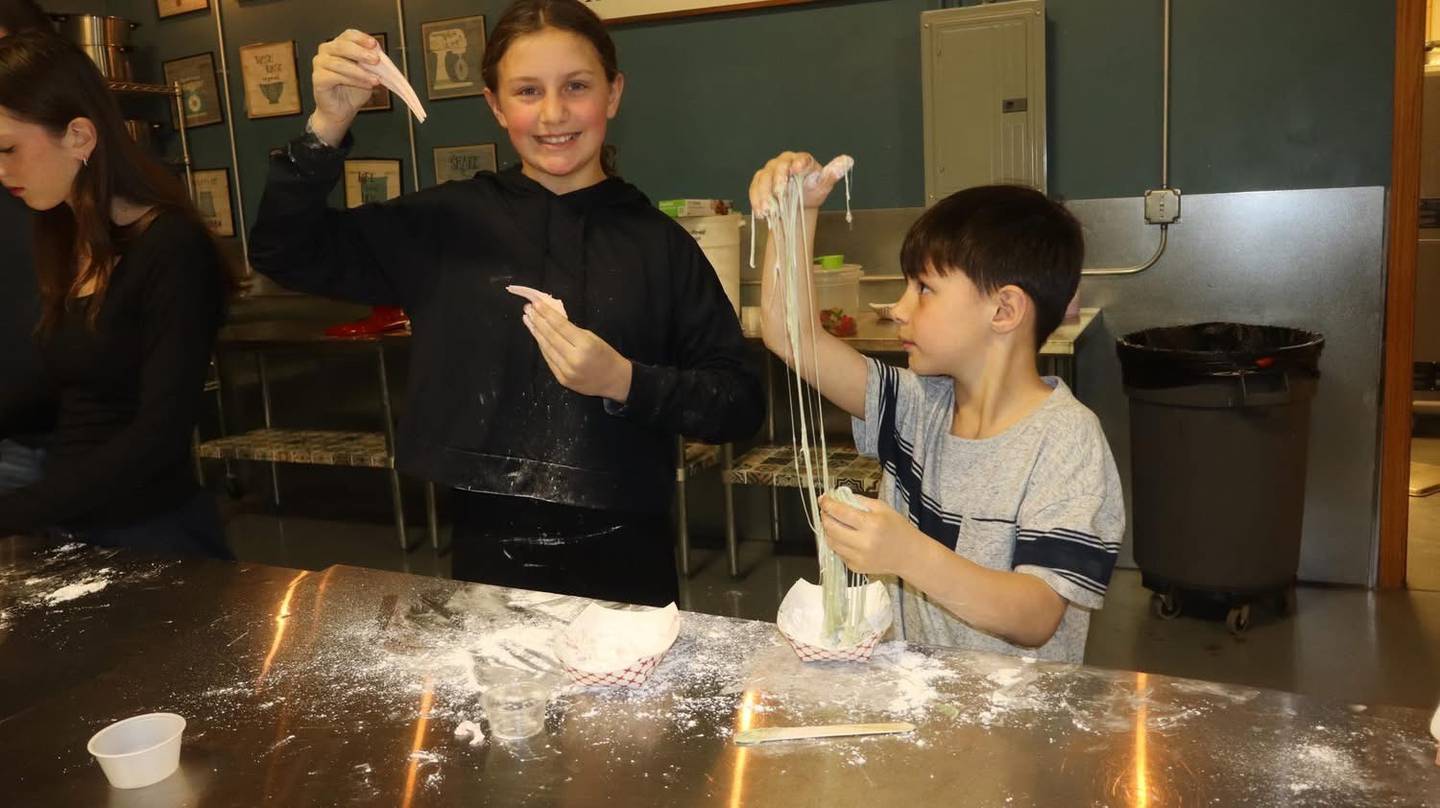 Juniper and Theo King prepare edible slime at the Farmhouse Academy in Mokena.