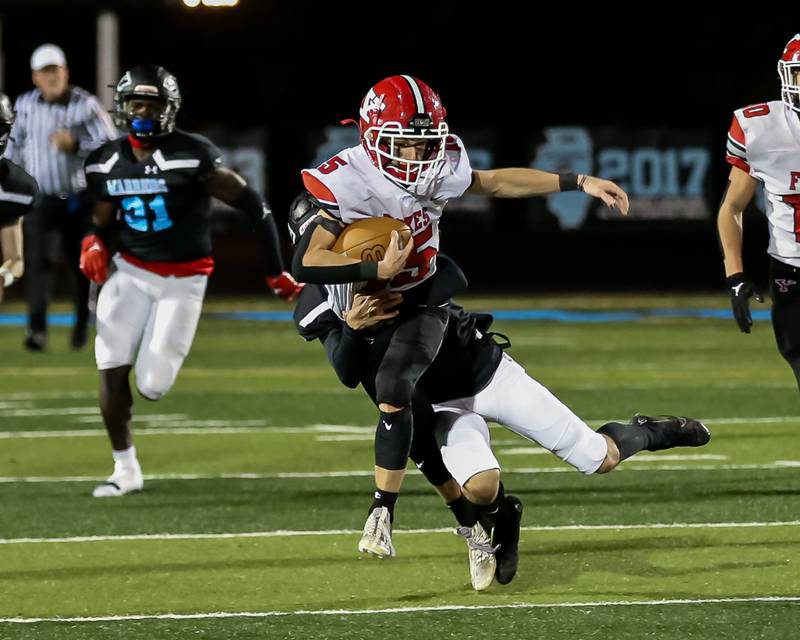 Yorkville's Dillon Jaskowski (15) is tackled by Willowbrook's Brandon Lopez (10) during Class 7A football playoff game between Yorkville at Willowbrook.   Oct 27, 2023.