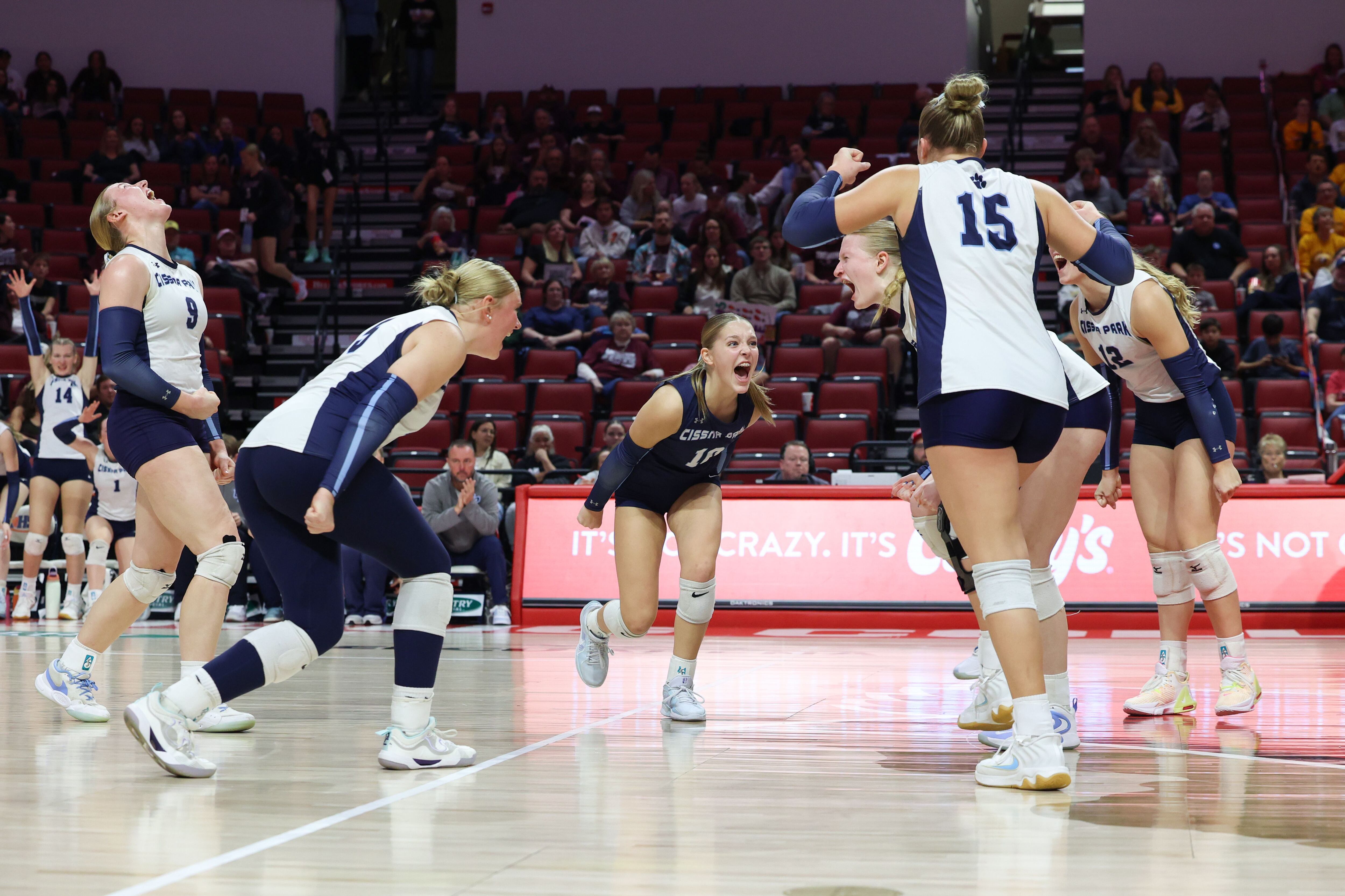 Cissna Park's Kendyl Neukomm, center, turns to celebrate a point with teammates during the Timberwolves' victory in two sets, 25-11, 25-14, over Stockton in the IHSA Class 1A State championship on Saturday, Nov. 15, 2025.